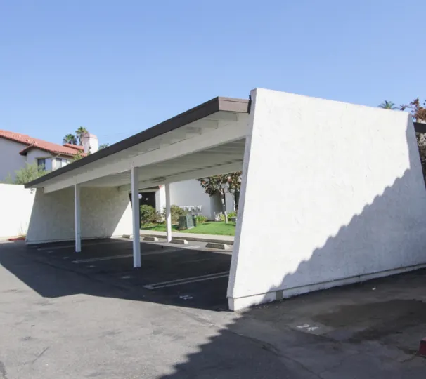 An empty parking lot with white walls in Adobe Hills neighborhood
