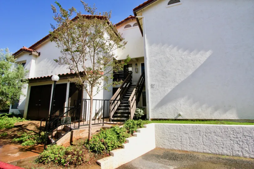 front stair entrance of the building have trees in front in Adobe Hills