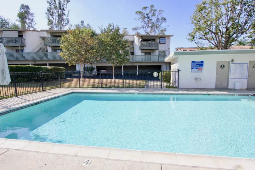 Large fenced in swimming pool with change rooms in Escondido