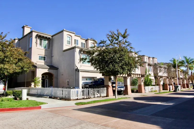 Street view of the building decorated with plants and trees with care parking in Escondido Park Row