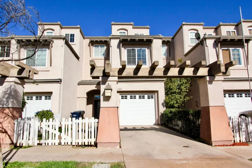 Front view of a townhouse in the Escondido Park Row community on a sunny day