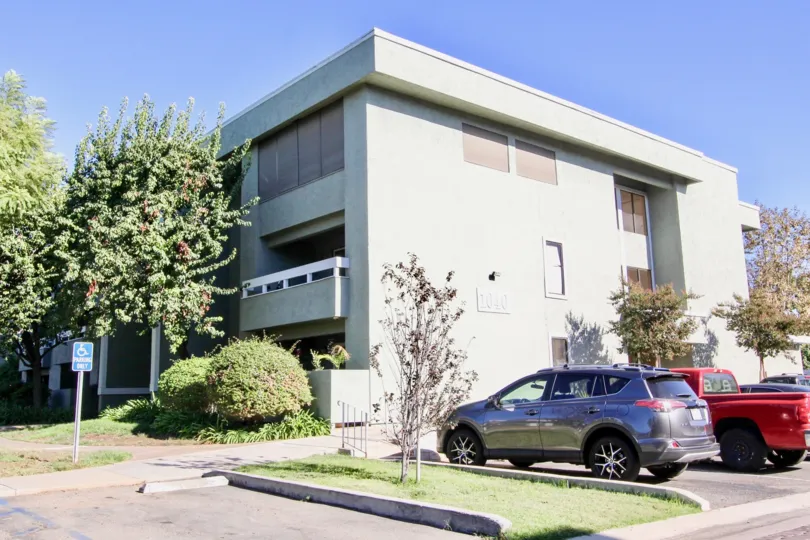 Three story residential units next to parking lot at Escondido Village in Escondido California