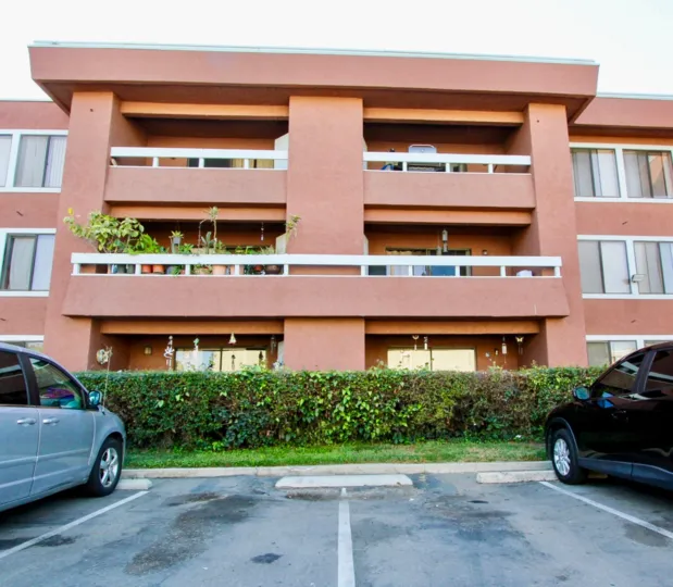 Brick and orange color painting home with balcony in Escondido Village.