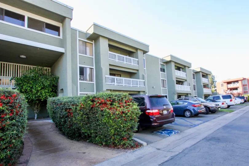 Parking in front of three story residential buildings at Escondido Village in Escondido California