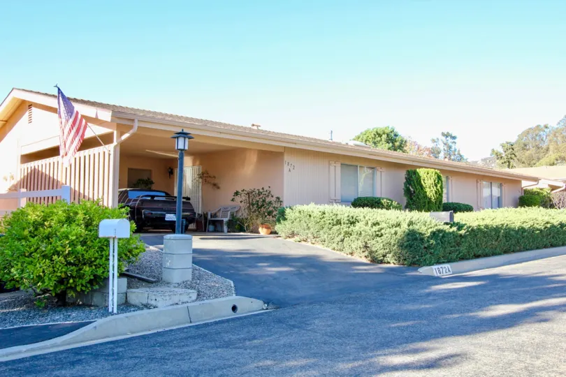 Large home with driveway and green plants at Fairway Park in Escondido California