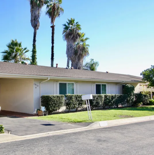 Housing units near yard and beneath palm trees at Fairway Park in Escondido California