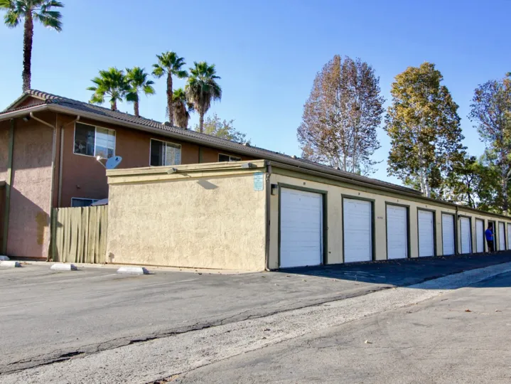 Alleyway lined with parking garages at Grand Tree Park in Escondido California