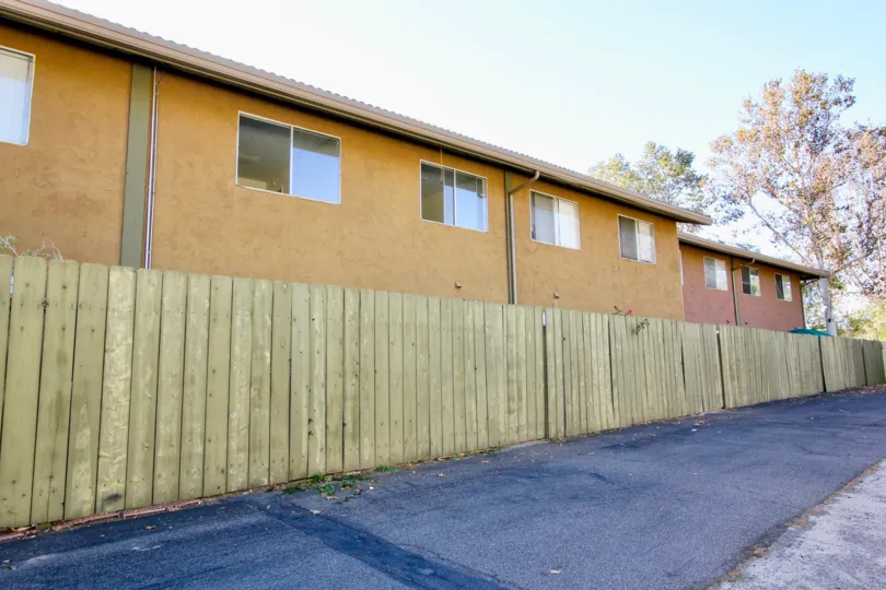 Two story residential units with fence at Grand Tree Park in Escondido California