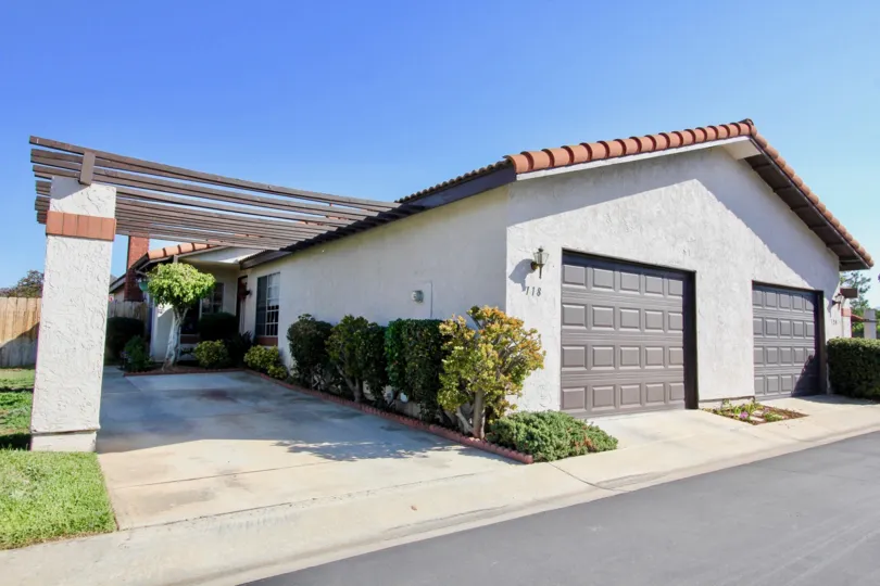 White home with two garages on the side of the road in Heather Glen, Escondido, California.