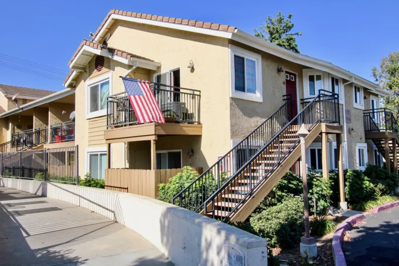 THE BUNGALOW IN THE HERITAGE AT CANYON POINT WITH THE UPSTAIRS, NATIONAL FLAG, PLANTS, PATHWAY