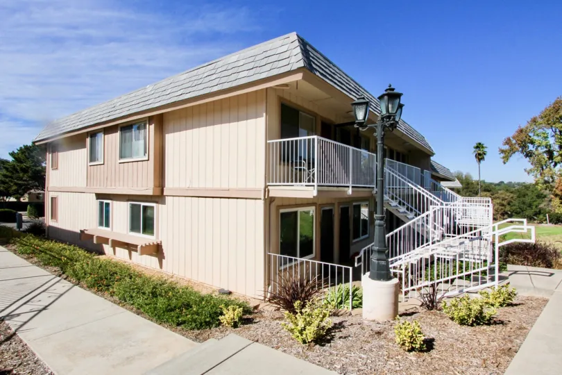 Two story residential building with stairway at Hidden Meadows Condos in Escondido California