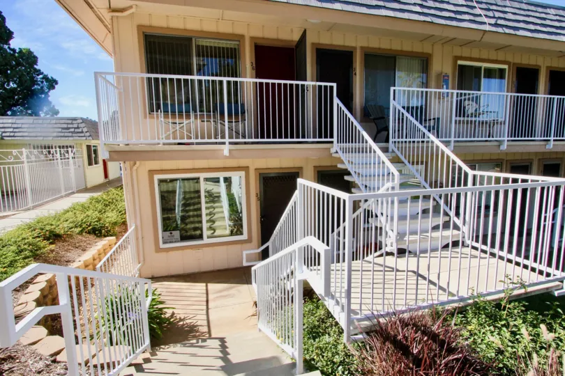 A house Door is open in Hidden Meadows Condos and has bushes at the side