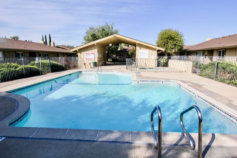 A covered pool house provides access to a pool at Holiday Gardens