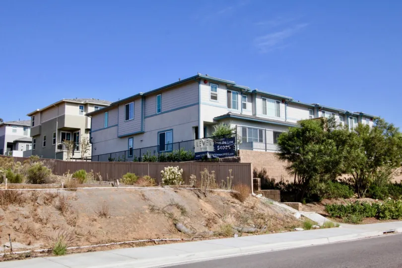 Two story residential buildings with security fence at Level Fifteen in Escondido California