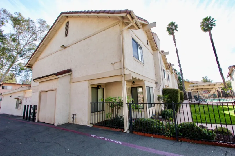 Martin Court Gardens community Escondido California palm trees grass shrubbery fence garage covered entry tile roof pool grass sidwalks
