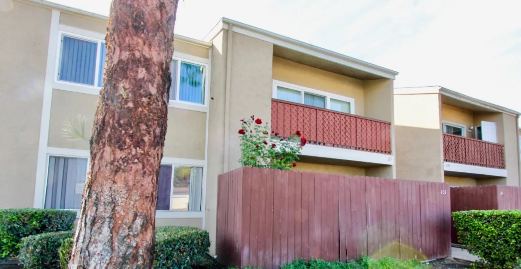 Midway North community Escondido California balcony windows tree shrubbery hedges fence landscaping