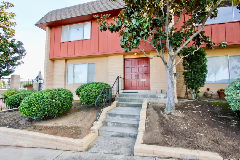 Two story housing unit with stairway leading up to it's entrance at Monte Cristo Villas in Escondido California