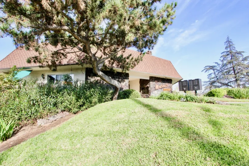 A clubhouse with a lawn in the Montecristo Villas South community.