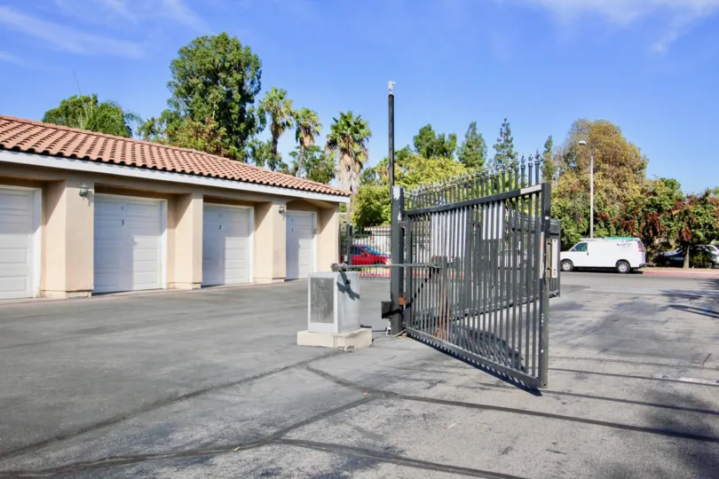 The Main Gate of Villas in Mountain View Villas is open and car is parking