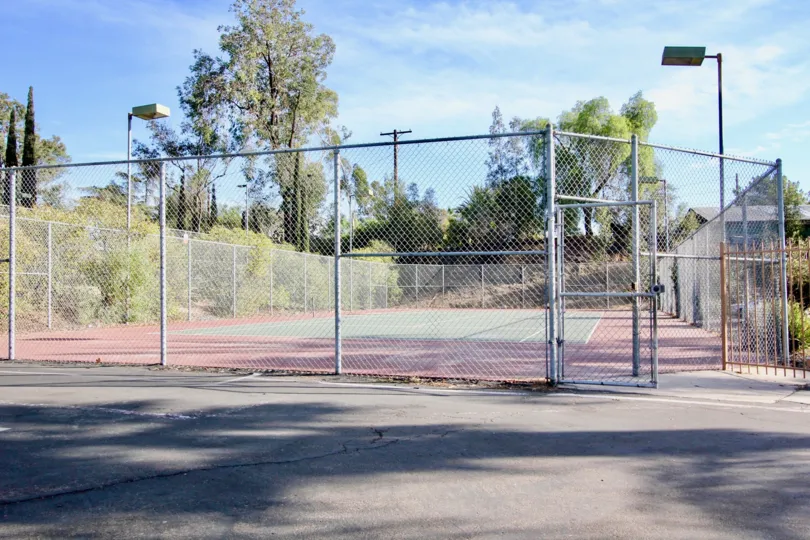 Tennis court surrounded by trees at Rock Springs East in Escondido California