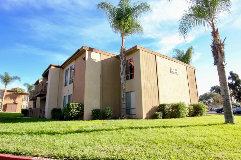 Two story housing surrounded by a green yard at Rock Springs West in Escondido California