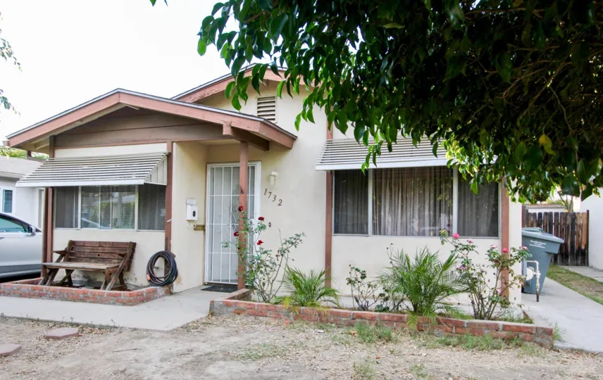 One story house with plants out front and a long chair, located in Rosedale Manor, Escondido, California.