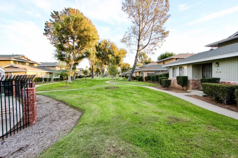 Large shared greenspace with walking paths and mature trees in Shadow Mountain