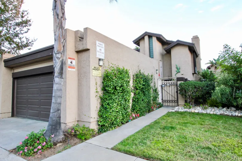 Lush green yard in front of security gate at Skylark Terrace in Escondido California