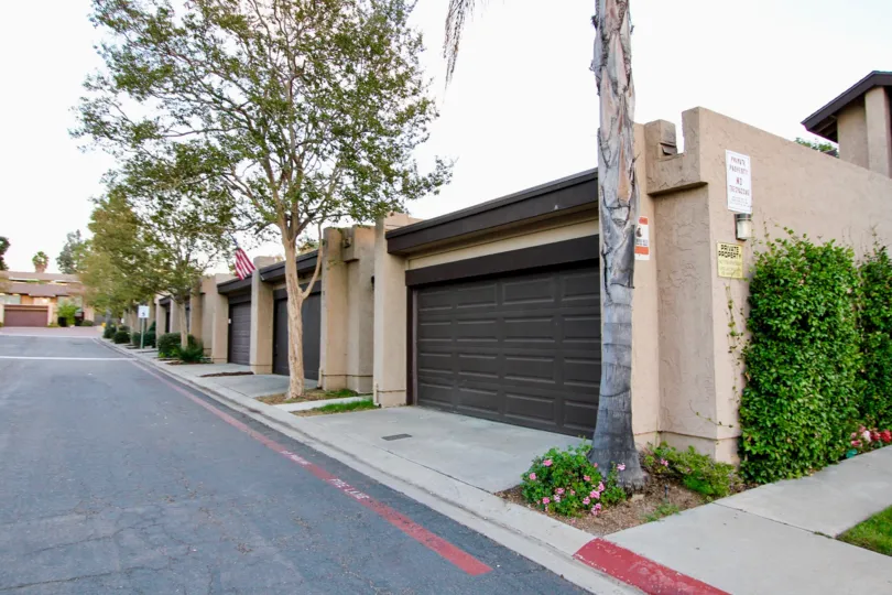 Garages with black doors on an empty street in Skylark Terrace neighborhood