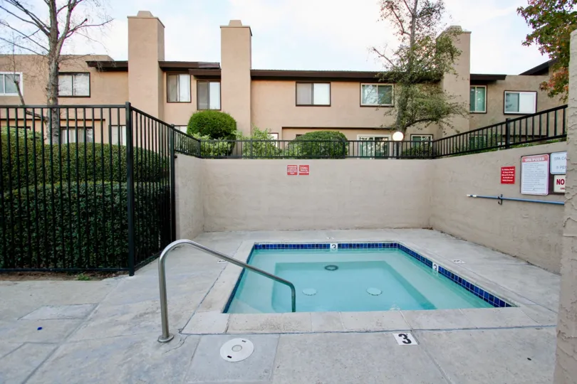 Gated Spa Pool at Skaylark Terrace, Escondido surrounded with green hedges