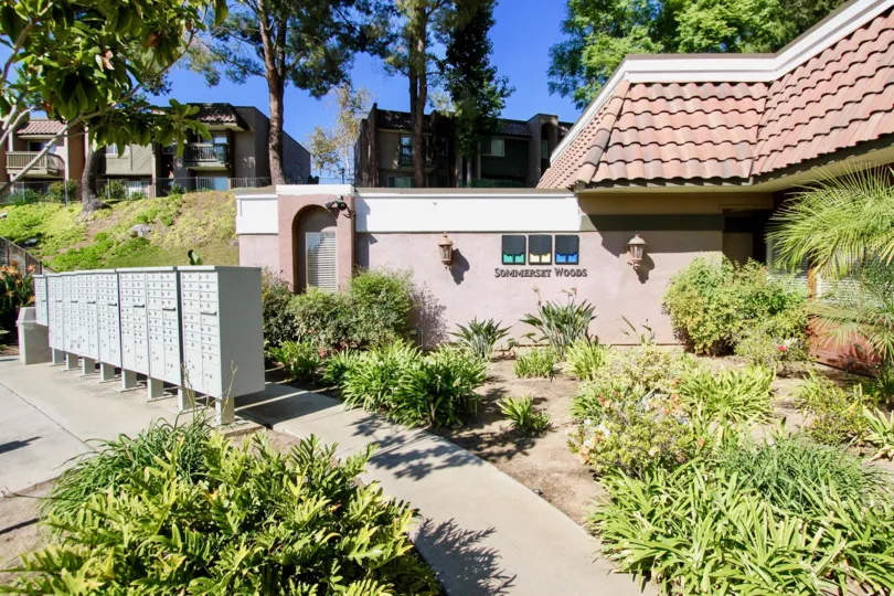 A row of mailboxes stand next to a landscaped walkway at the Sommerset Woods community in Escondido, California.