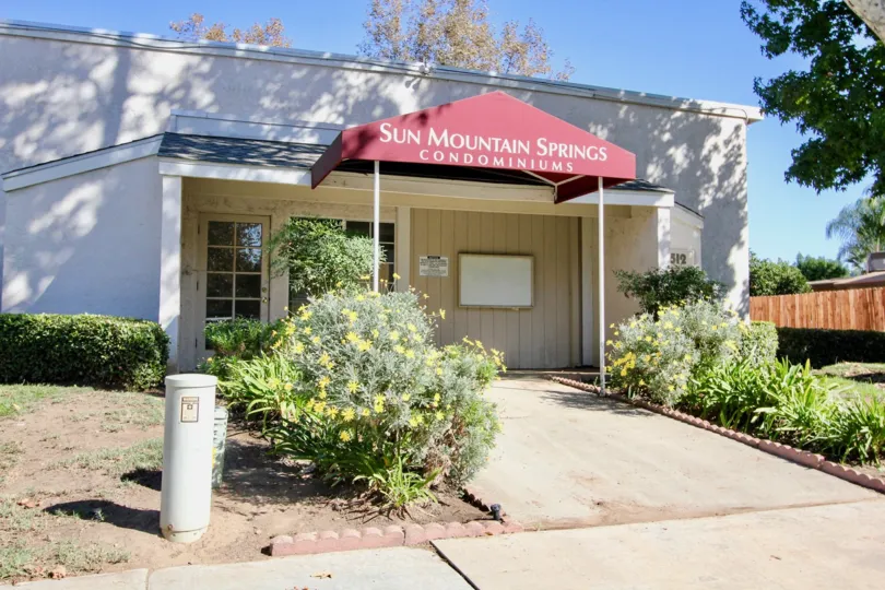 A red fabric awning provides shade to an entrance way at Sun Mountain Springs