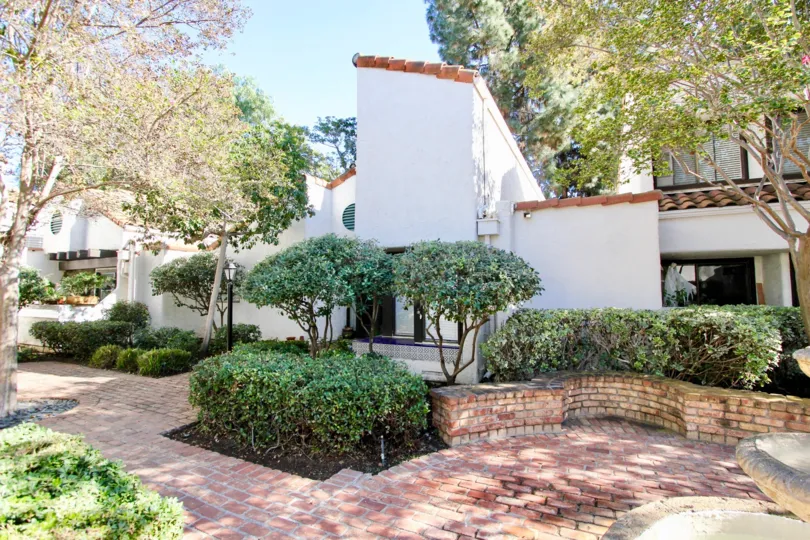 Beautiful brick paved walkways and retaining walls with ample plants and trees at Sunset Woods