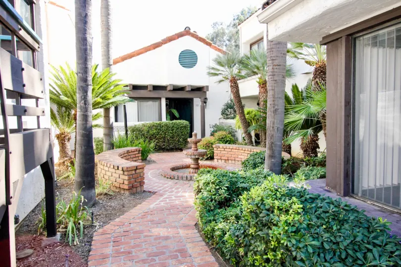 Brick courtyard with fountain to enjoy on your walks at Sunset Woods.