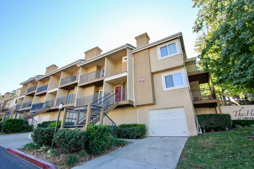 The front of an apartment building in the The Heritage community in Escondido, Ca on a beautiful day.