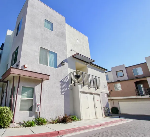Contemporary styled units with iron railings and cobblestone roads at Urbana in Citracado Village