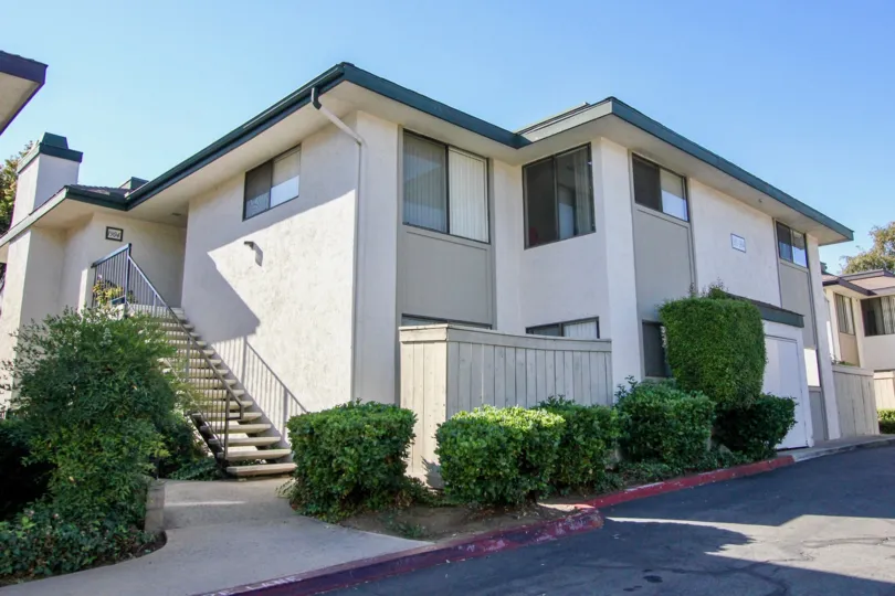 Two story housing with attached stairway near driveway at Vermont villas in Escondido California