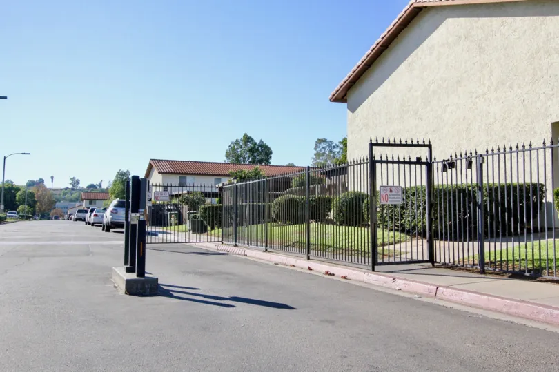 Street view of the buildings with trees and cars parked in Villa Espanas