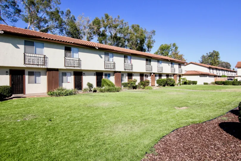 Town-homes next to lush green yard at Villa Espanas in Escondido California