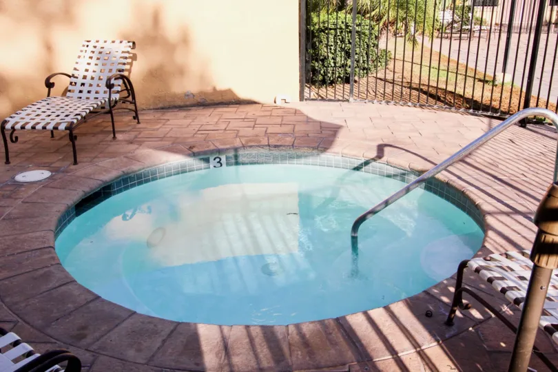 Hot tub surrounded by black security fence at Villa La Paz in Escondido California