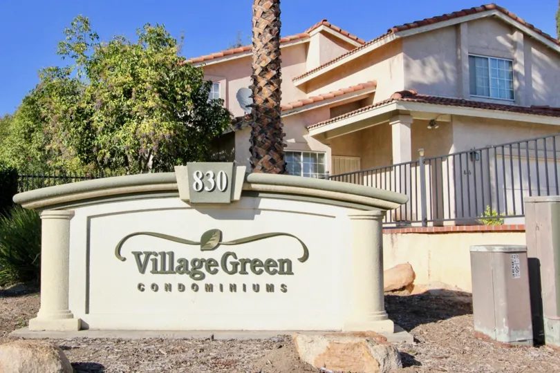 Community sign near entrance at Village Green in Escondido California