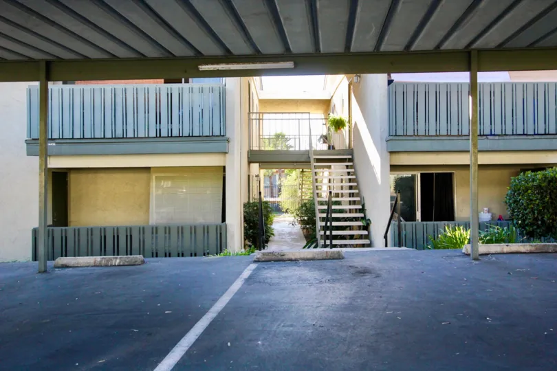 Covered parking in front of two story residential buildings at Village green in Escondido California