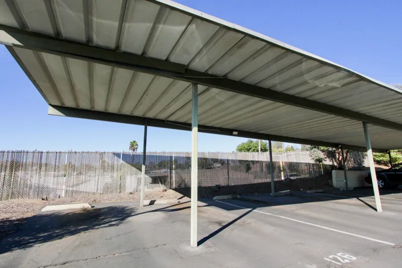 Parking spaces near a fence at Village Green in Escondido California