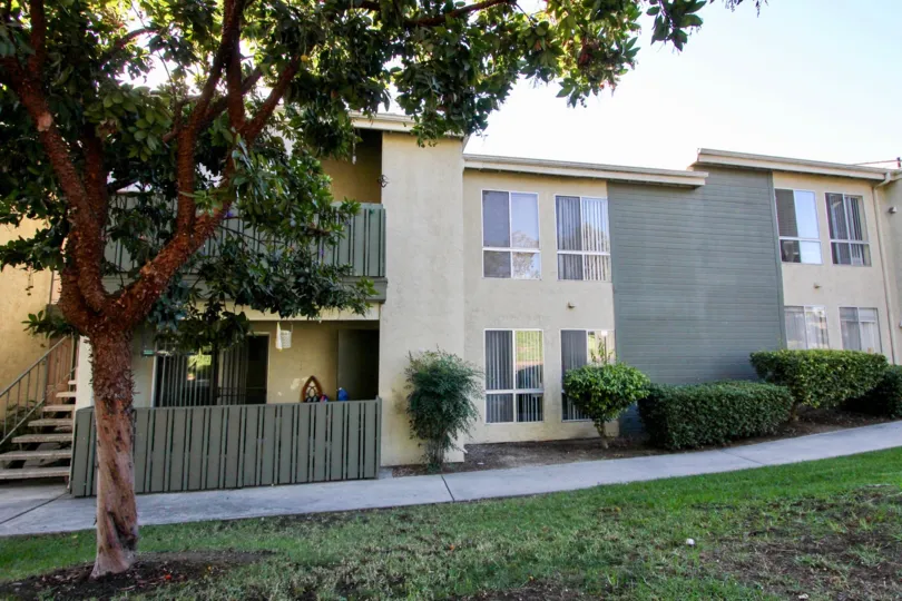 Two story residential units next to a sidewalk at Village Green in Escondido California