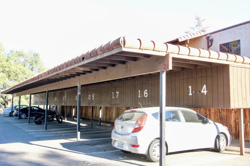 white hatchback is parked under a carport at Vista Del Mundo condos