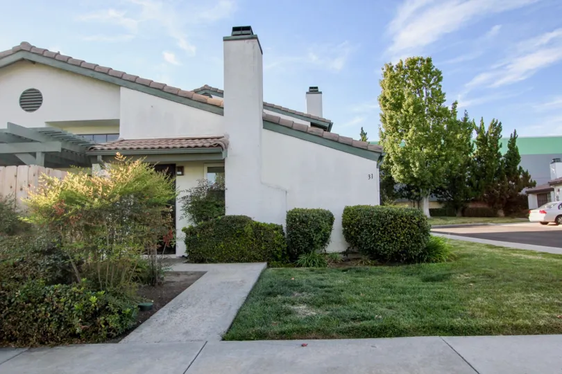 Sidwalk leading up to residence next to a green yard at Westwinds I in Escondido California