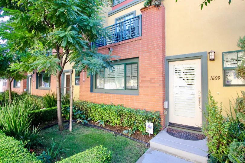 Near the door of the house in 12 on Polk has 1609 and with meadow of plants and bushes