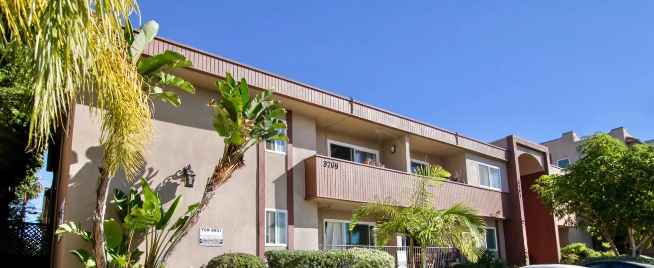 A two-storey townhouse in reddish paint in 3769 1st Ave community.