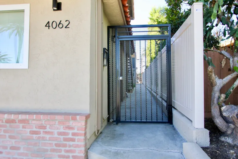 An entrance of a building in the 4062 Georgia with beautiful plants.