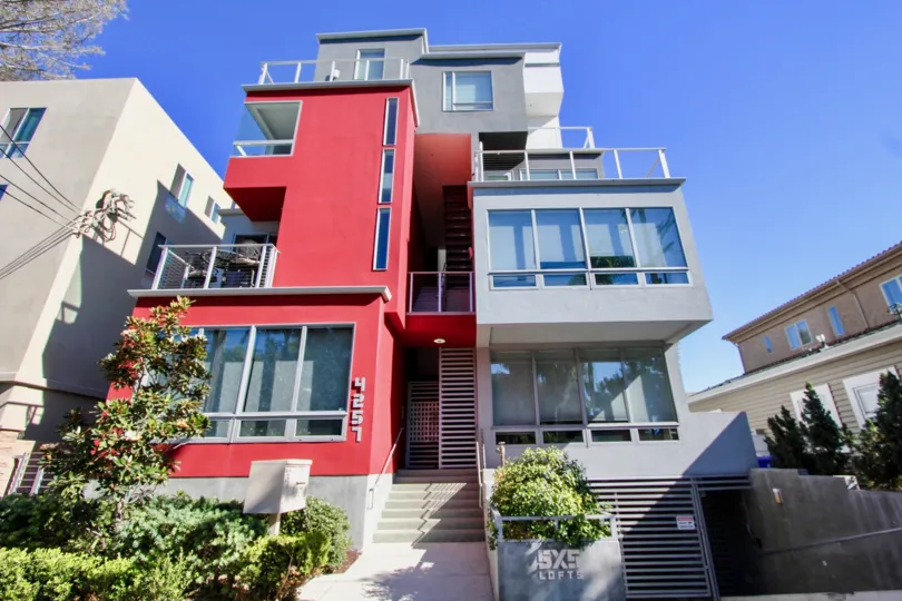 A contemporary three-storey residence painted in red and gray in the 5x5 Lofts community.